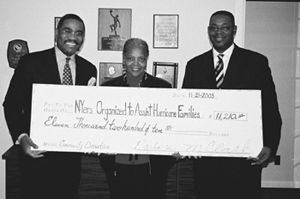 Congressman Gregory Meeks accepting a check on behalf of Katrina fund